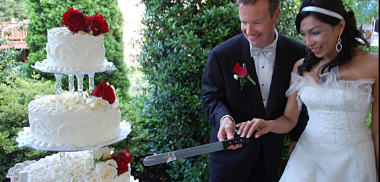 International Introductions Marriage Colombian woman and American man cutting wedding cake