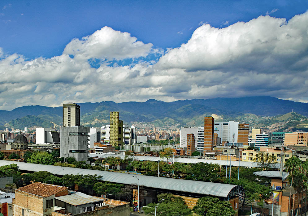 A sunny day in Medellin with white clouds over the mountains