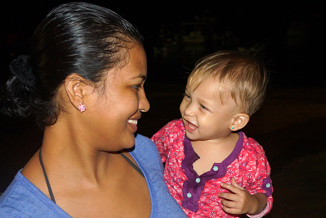 Mom and her one year old Colombian American sharing smiles at each other