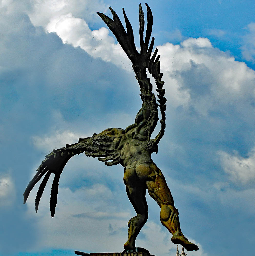 Bolivar Condor Statue A statue of the back of a man with wing under blue sky