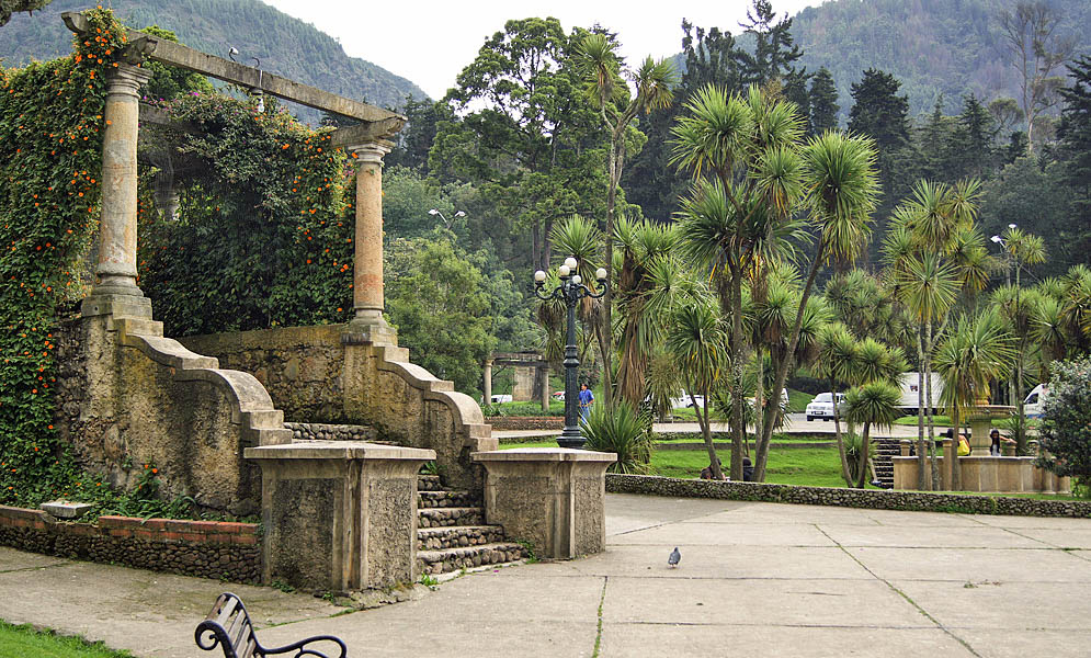 Bogotá Park with Vine Arbor A stone vine arbor with orange flowers in a park