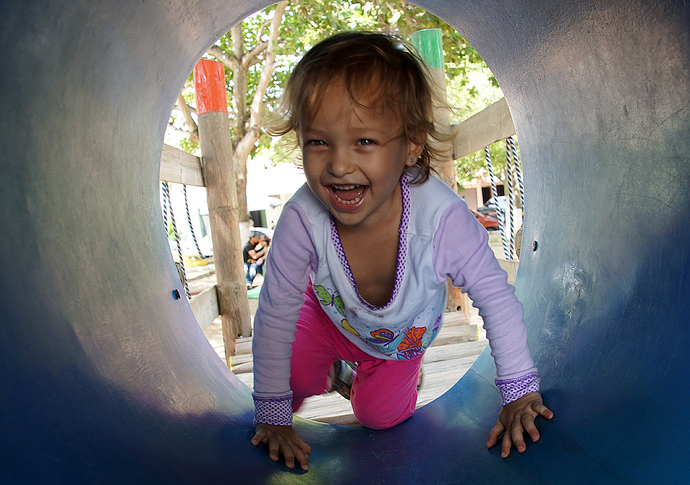 A laughing child playing in the playground