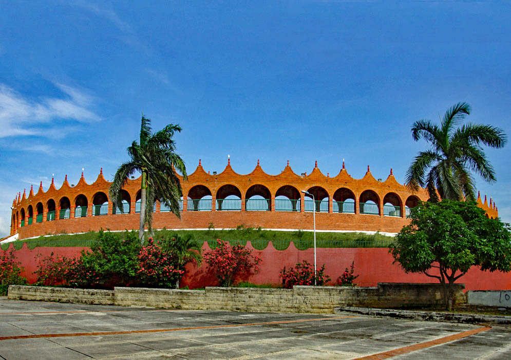 A red and rust-orange stadium used for bullfights