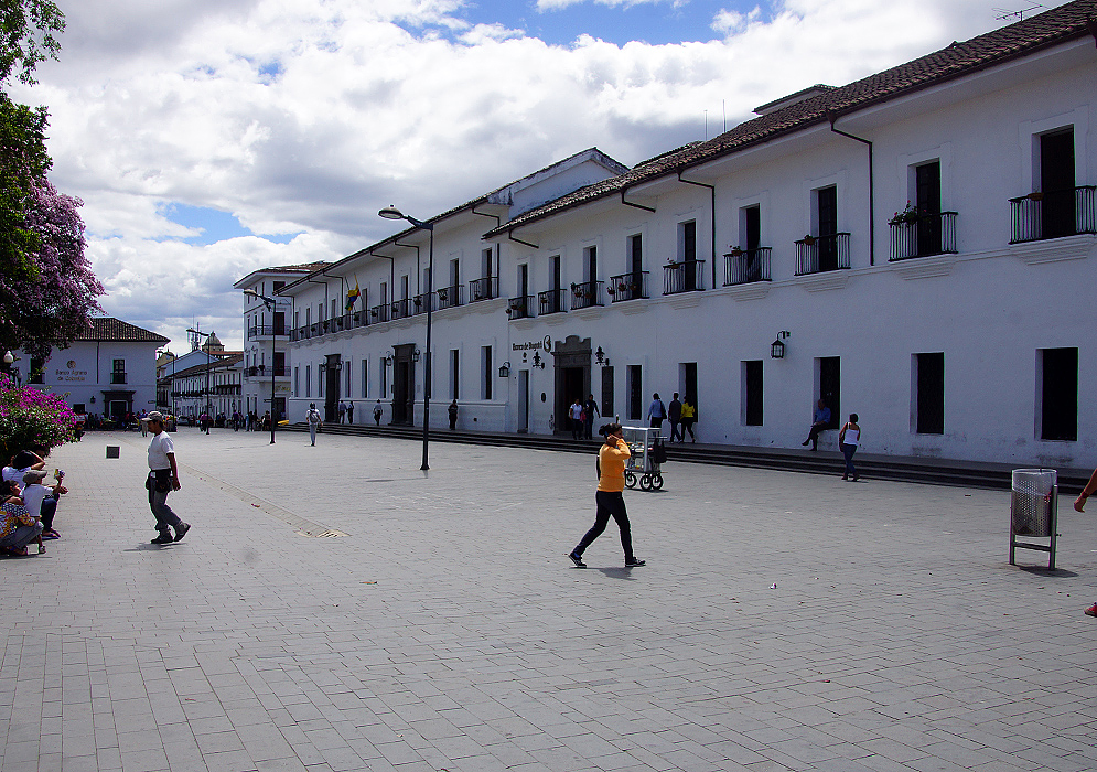 A block of white buildings  near the plaza