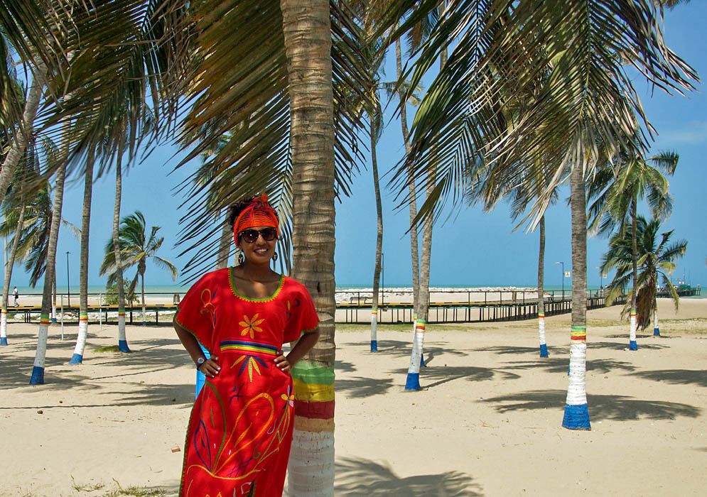 Woman in Wayuu outfit on the beach in front of Riohacha pier
