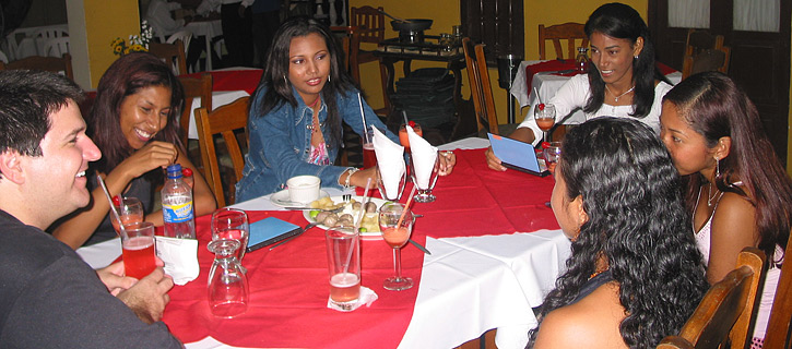 A small group of Latin women meeting one man during a romance tour at a restaurant