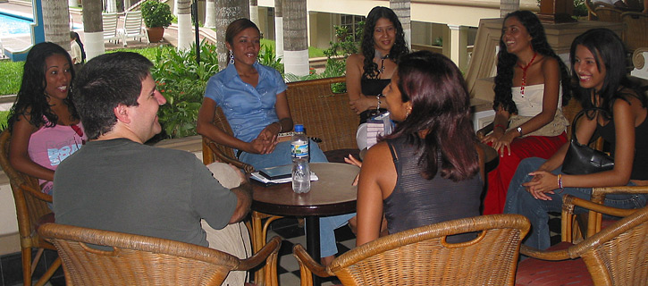 A small group of Latin women meeting one man during a romance tour at a restaurant