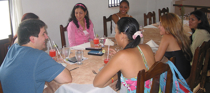 A small group of Colombian women meeting one man during a romance tour at a restaurant