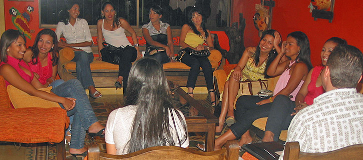 Smaller group of Colombian women in discussion with a guest in the living room