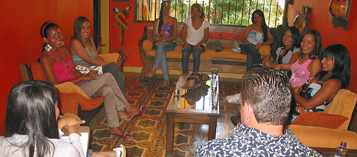 One man being introduced to a small group of attentive Latin American women