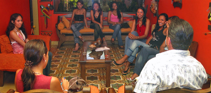 One man being introduced to a small group of lovely Latin women in a private setting