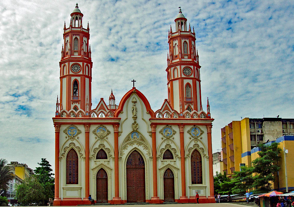 Front of church with two towers colored pink and white