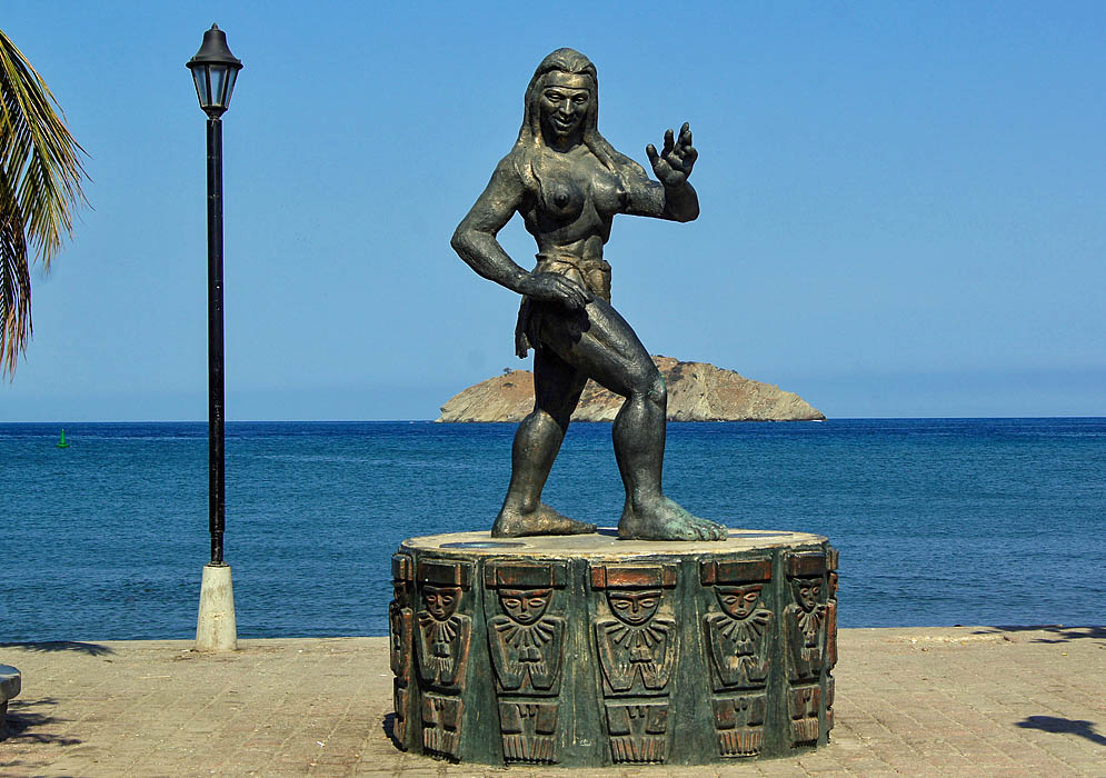 A statue of an Indian with a small rock island in the background
