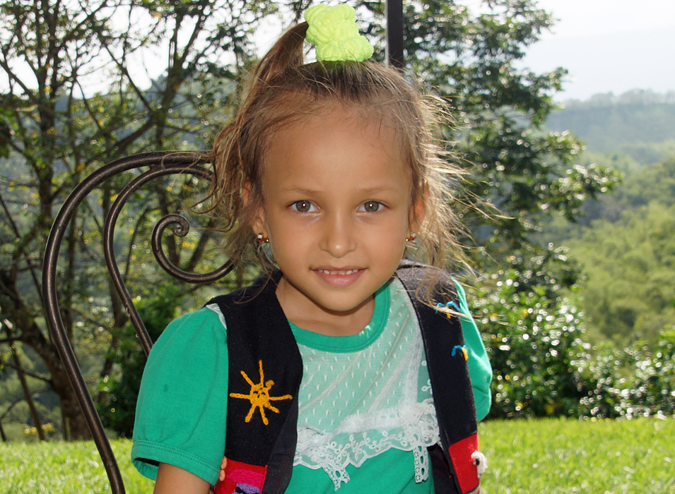 Wearing a green shirt and hair piece a little girls looks stunning