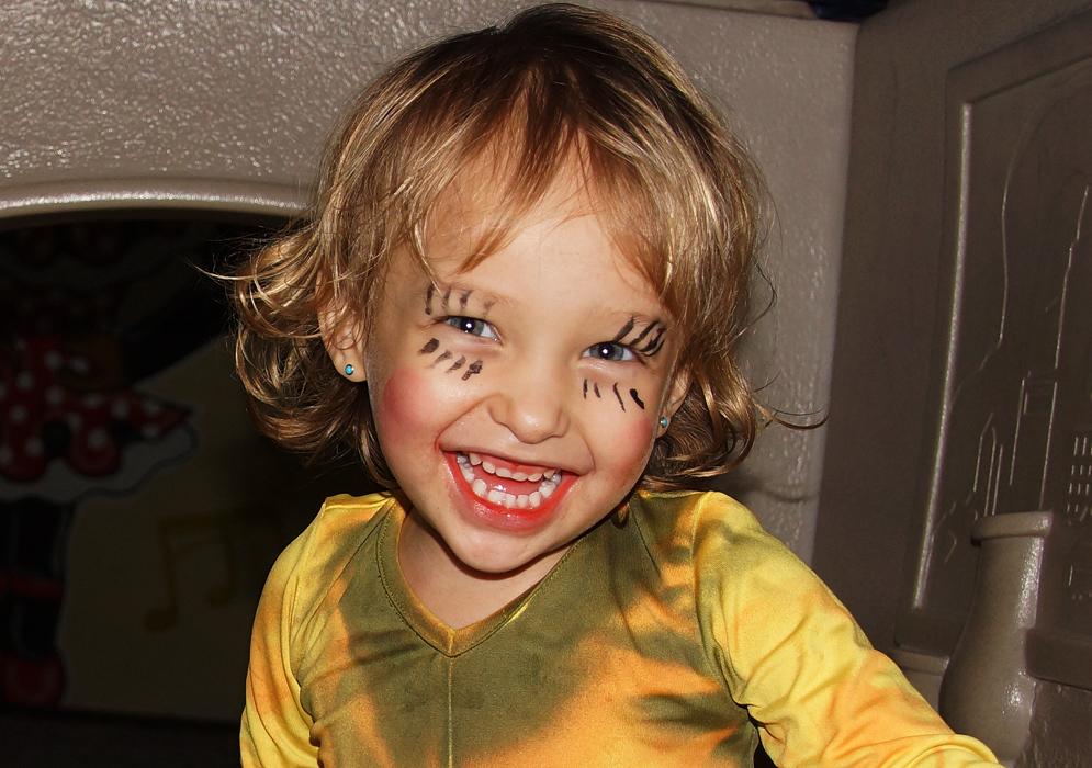 Halloween joy from a beautiful little girl enjoying her decorations