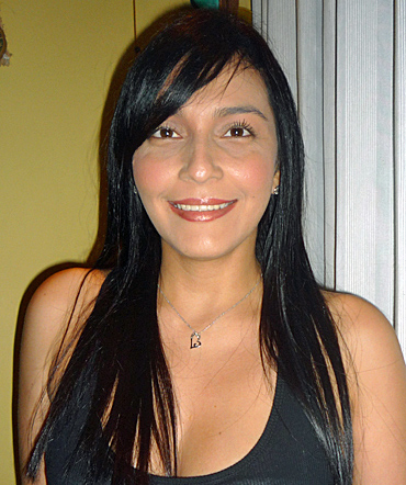 Woman Colombian Pretty Colombian woman with long straight black hair, warm brown eyes, and a bright friendly smile, looking directly at the camera with an open and inviting expression