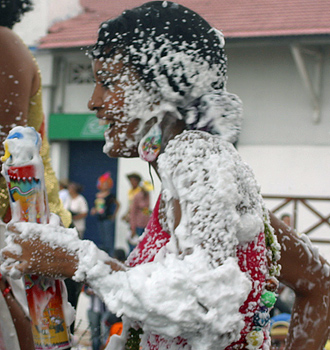 Carnival spectators covered in white foam