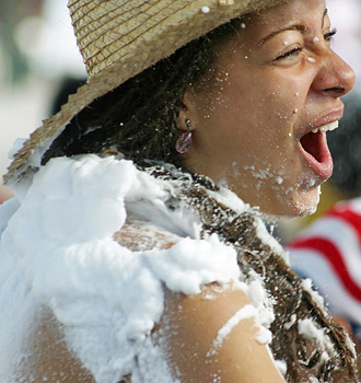 Carnival spectators covered in white foam