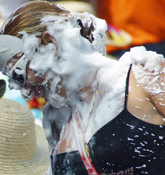 Carnival spectators covered in white foam